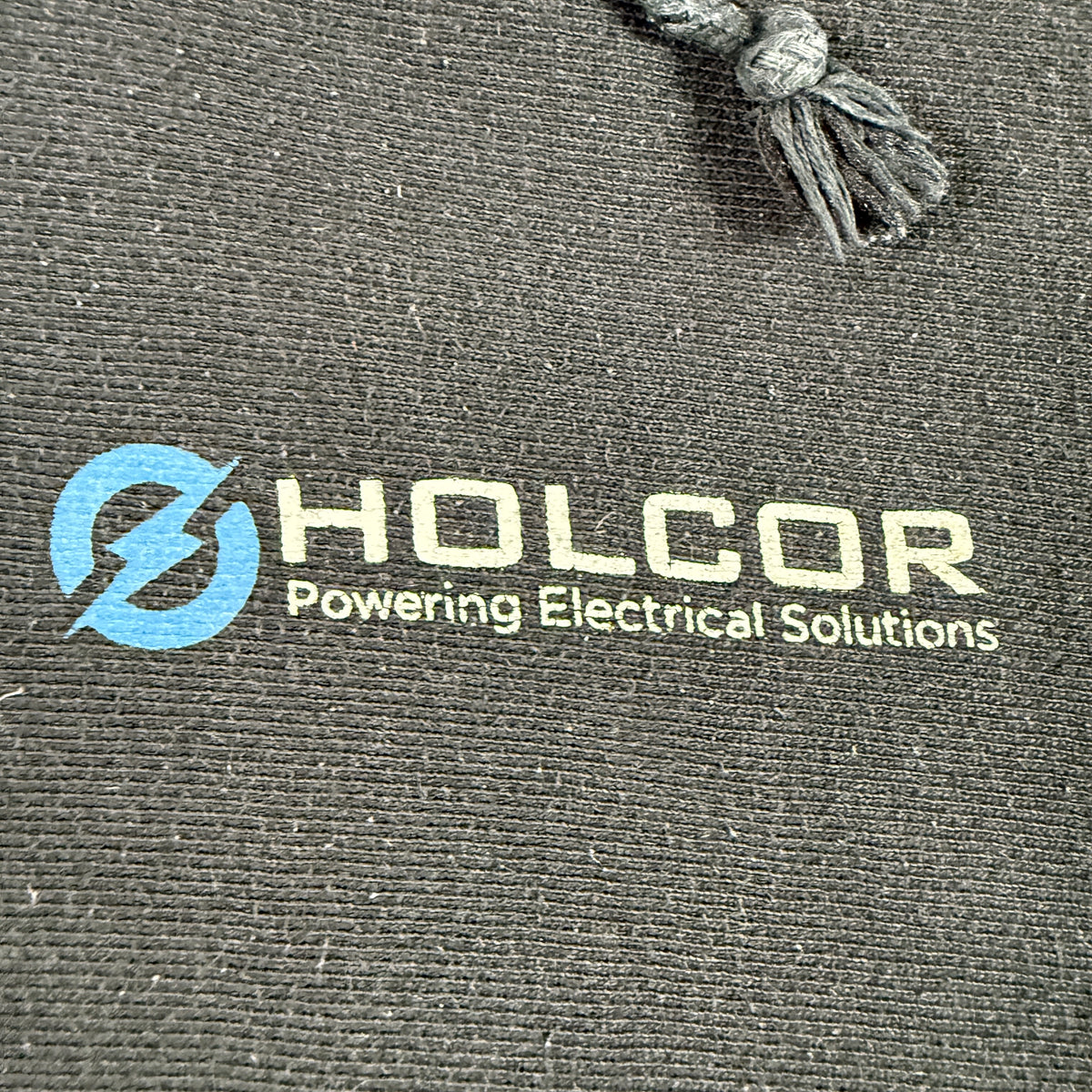 左胸の HOLCOR Powering Electrical Solutions プリント 寄り
